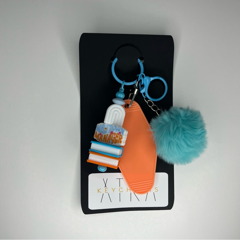 Orange and Blue Keychain with Pom Pom and Meltdown Manager